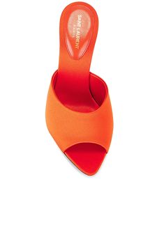 Find SAINT LAURENT Suite Mule Sandal In Orange on Editorialist. Saint Laurent Suite Mule Sandal in Orange Satin upper with leather sole. Made in Italy. Slip-on styling. Satin footbed with leather lining. Pointed toe with flare heel. Approx 100mm/ 4 inch heel. SLAU-WZ1213. 766829-AAC4I-7516. About the designer: SAINT LAURENT has been influencing and revolutionizing the fashion industry since the debut of its iconic ‘Rive Gauche’ collection in 1966 - the couture house was the first to create a ready-to-wear capsule. The sleek, precisely tailored staples, like the signature biker jackets, transcend seasons and trends. Creative Director Anthony Vaccarello continues to honor the label’s illustrious reputation by reintroducing cult styles, including the ‘Lou’ handbag and ‘Tribute’ sandals. Designer Slip-on Sandals With Sculpted Heel, Designer Mules With Heel Strap And Single Toe Strap, Designer Slip-on Heels With Heel Strap, Orange Closed Toe Evening Sandals, Evening Closed Toe Orange Sandals, Evening Orange Sandals With Heel Strap, Luxury Orange Evening Sandals, Orange Sandals With Wrapped Heel And Pointed Toe, Designer Orange Sandals For Party