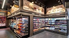 the inside of a grocery store filled with lots of food and drink bottles on display