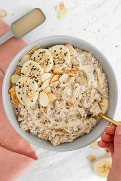 a bowl of oatmeal with banana slices and almonds in the middle