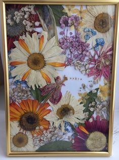 an image of flowers in a gold frame