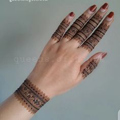 a woman's hand with henna tattoos on it