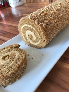 a close up of a roll on a plate with another roll next to it,