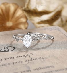 a diamond ring sitting on top of a piece of paper