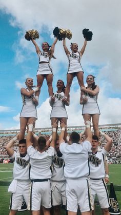 a group of cheerleaders standing on top of each other