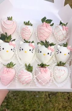 hello kitty chocolate covered strawberries in a white box with pink bows and strawberry decorations