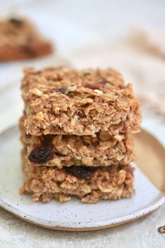 three granola bars stacked on top of each other with raisins in the middle