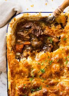 a casserole dish filled with meat and vegetables