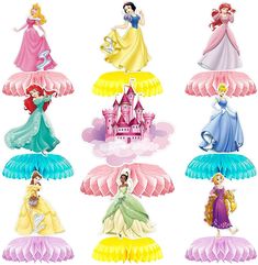 a group of princess figurines sitting on top of each other in front of a white background