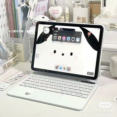 an open laptop computer sitting on top of a white desk