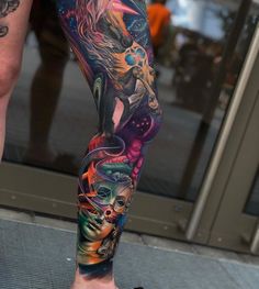 a man's leg with colorful tattoos on it