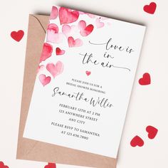 a card with hearts on it and the words love is in the air