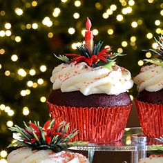 three cupcakes with white frosting and red sprinkles on them