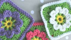 three crocheted squares with flowers are on a polka dot tablecloth, one is green and the other is purple