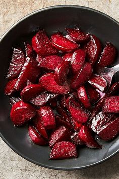 beets in a black bowl with a spoon on the side, ready to be cooked