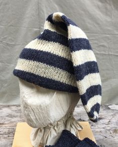 a knitted hat and mittens sitting on top of a wooden table