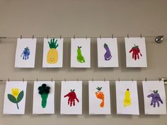 handprints are hung on the clothes line with magnets and paper clips attached to them