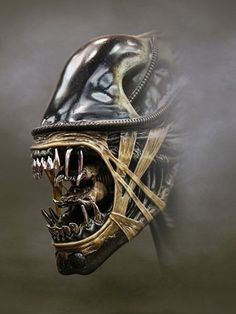 an alien head with large teeth and fangs on it's face is shown in the fog