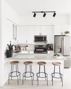 an instagram photo of a kitchen with stools in front of the counter top