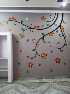 the wall is painted with flowers and leaves on it's side, as well as a shelf