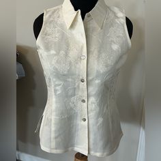 Gorgeous Sleeveless Embroidered Blouse. Creamy Off-White. Full Button Front With Beautiful Mother Of Pearl Buttons. Linen-Like Ramie/Cotton Blend. Brand New. 26 Inches Long. 20 Inches Pit To Pit. Elegant Sleeveless Button Blouse, Elegant Embroidered Sleeveless Vest, White Sleeveless Blouse With Buttons, Sleeveless White Blouse With Buttons, Elegant White Tank Top With Buttons, Elegant Embroidered Fitted Vest, Elegant Sleeveless Embroidered Top, Elegant Fitted Embroidered Vest, Classic Sleeveless Blouse With Buttons