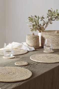 the table is set with baskets and place mats