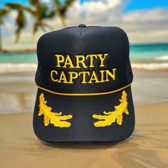 PARTY CAPTIAN embroidered on a black with gold leaf Otto Foam High-Profile Trucker Hat. *Message us if you are looking for a different color hat or thread or with any other questions. *Saying can be customized. Please message us before ordering.  Hat Description:  The Traditional Look 5-panel cap Seamless Foam Front Panel with Lining Matching Color Braid Visor Matching Fabric Undervisor, Adjustable Snapback SHAPE: High-Profile FABRIC:  100% Polyester Front,  Mesh Back VISOR: Pre-curved FIT & SIZ Novelty Costume Hats And Headpieces For Summer Party, Novelty Summer Party Costume Hats And Headpieces, Summer Party Novelty Costume Hats, Halloween Party Costume Cap, Novelty Mini Hats With Curved Brim For Party, Novelty Mini Hat With Curved Brim For Party, Novelty Summer Party Hats, Novelty Mini Cap Hats For Party, Halloween Party Mini Cap Hats