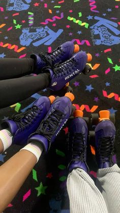 three people are riding roller skates on a carpet with colorful stars and shapes around them