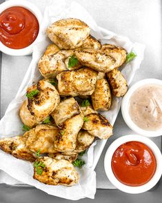 grilled chicken wings with ketchup and dipping sauces on the side, ready to be eaten