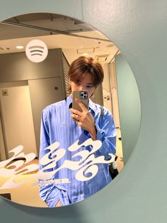 a person taking a selfie in front of a mirror with music notes on it