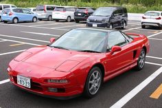 a red sports car parked in a parking lot