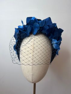 Beautiful Hydrangea Halo headband with birdcage veil, blue ombré hydrangea petals sit to create a halo on a large velvet blue coloured headband.  This Headband is stunning, perfect for all summer events, weddings and races. Brand New. If you need your item by a certain date please let me know. Made in the UK. Custom orders are welcome. Many more items are available in our Shop. Returns Please notify us within 3 days of receiving your item if you intend to return it. We allow 7 days from the date of receipt of the headpiece to return it to us, our returns requirements are that it is returned properly packaged to prevent damage in the post, it is unworn/as new condition and has not had the tag tampered with in any way. Please double check it will meet these requirements before returning as w Blue Birdcage Veil, Blue Wedding Fascinator With Handmade Flowers, Blue Adjustable Fascinator For Wedding, Adjustable Blue Fascinator For Wedding, Blue Handmade Flowers Headband, Formal Blue Fascinator With Handmade Flowers, Blue Headband With Handmade Flowers, Blue Fitted Headpiece With Handmade Flowers, Fitted Blue Headpiece With Handmade Flowers