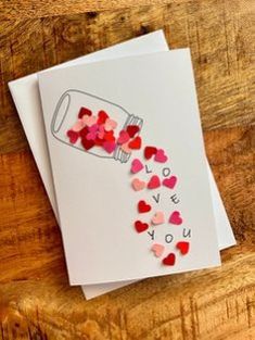 valentine's day card with hearts spilling out of a bottle that says i love you