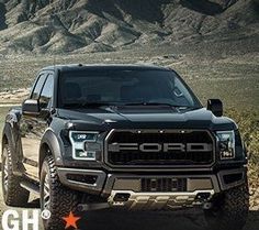 a truck driving down a dirt road with mountains in the backgrouund and an ad for ford