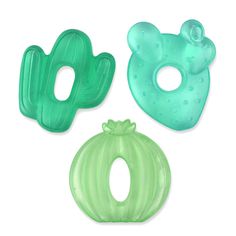 three green and blue plastic objects on a white surface, including a mask, an onion shaped object with holes in the middle