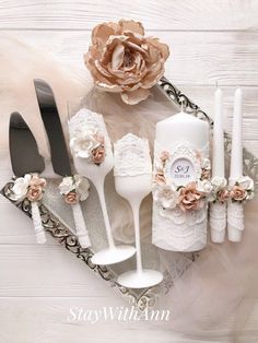 there is a table setting with flowers and candles on the tray, along with utensils