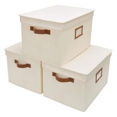 three white storage boxes with brown handles