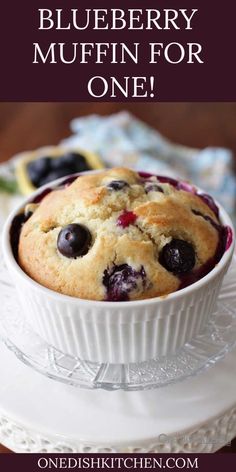 a blueberry muffin in a white dish on a plate