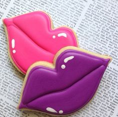 two cookies shaped like lips sitting on top of an open book