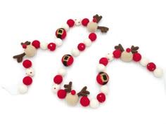 a white and red beaded christmas garland with reindeer heads on it's sides