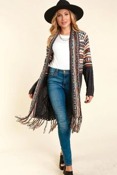 L.I.B. New York Charcoal and ivory tribal shawl cardigan, crafted with a boho ethnic tribal pattern and two-tone long sleeves. This midi length cardigan boasts fringe tassels, a warm and cozy soft stretchy knit, and will flatter any outfit. Color: Charcoal Ivory and multicolor One Size Fits S-M-L Length Back 35", Across 20" underarm to underarm. 5" fringe. 41% Polyester, 36% Cotton, 23% Rayon, hand wash cold, imported D1/ECD10390 Black Fringe Cardigan For Winter, Bohemian Multicolor Fringed Cardigan, One Size Long Sleeve Fringe Cardigan, Black Fringe Long Sleeve Cardigan, Casual One-size Shawl With Fringe, Shawl Cardigan, Tassel Fringe, Warm And Cozy, Midi Length