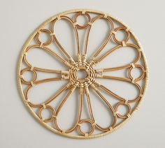 a decorative wall hanging made out of wicker with circles on the center and sides