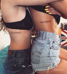 two women with matching tattoos on their stomachs