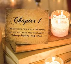 a table topped with two candles and a sign that says, chapter 1 whatever our soul is made of, his and mine are the same