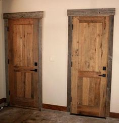 two wooden doors sitting next to each other in a room