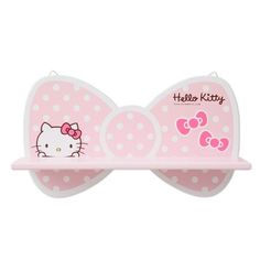 a pink hello kitty hair clip with polka dots on it's head and the word hello kitty