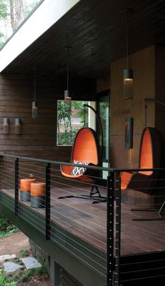 an orange chair sitting on top of a wooden deck