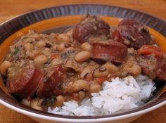 a bowl filled with rice and beans on top of a wooden table