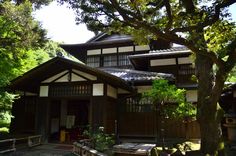 an old japanese style house surrounded by trees