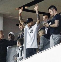 a group of men standing next to each other at a soccer game