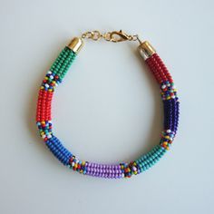 Introducing our special Handwoven Multi-color Bracelet! This unique bracelet is made with tiny Toho seed beads using a technique called Herringbone Stitch, and it's perfect for adding a touch of bohemian charm to any outfit. 🌈 Many Colors: This bracelet comes in a rainbow of colors, so it is the perfect  one that makes you or your friend the happiest. 🎁 Perfect Gift: Looking for a special gift for her? This bracelet is a fantastic choice. It's one-of-a-kind and sure to make her smile. All of our jewelry comes with our branded box so it is ready to be gifted 🌼 Bohemian Style: The bracelet has a bohemian, free-spirited vibe that's perfect for people who love unique and artistic jewelry. 💪 Handwoven: Each bracelet is carefully woven by hand and made with care in Istanbul, Turkey which mak Bohemian Rainbow Beaded Bracelets For Jewelry Making, Multicolor Hand-strung Heishi Beads Friendship Bracelets, Multicolor Tiny Beads Necklace For Friendship, Bohemian Heishi Beads Beaded Bracelets, Rainbow Heishi Beads Bracelet For Festival, Bohemian Rainbow Friendship Bracelets Hand-strung, Bohemian Rainbow Beaded Friendship Bracelets, Bohemian Rainbow Hand-strung Friendship Bracelets, Bohemian Rainbow Bracelets With Tiny Beads